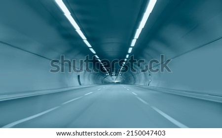 Abstract speed motion in blue highway road tunnel Royalty-Free Stock Photo #2150047403