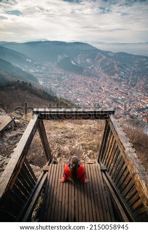 Panoramic view from the Tampa peak located in Brasov, Transylvania. The girl is looking at the old town. Great hiking route to the top. High resolution photography with great colors. 