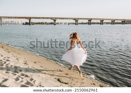 Wedding photosession at sunset of a beautiful couple, the bride in a white dress, and the groom in a white shirt and black trousers
 Royalty-Free Stock Photo #2150062961