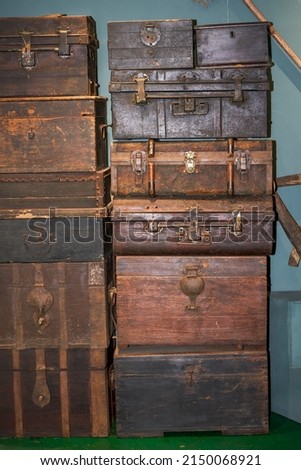 Pile of old vintage big wooden boxes stacked in a furniture store