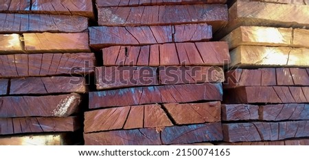 Stack of Building Lumber. Raw wood drying in the lumber warehouse. Wood timber stack of wooden blanks construction material. Industry. Royalty-Free Stock Photo #2150074165