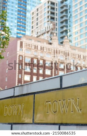 Tiled wall with typography and buildings in the background in downtown Seattle