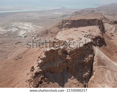 Aerial view of ruins of fortress Masada National Park, Southern District of Israel. Ancient fortification built by Herod the Great on a cliff-top off the Dead Sea coast. In UNESCO World Heritage List Royalty-Free Stock Photo #2150088257