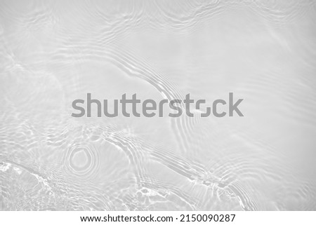 Desaturated transparent clear water surface texture with ripples, splashes Abstract nature background. White-grey water waves overlay Copy space, top view. Cosmetic moisturizer micellar toner emulsion