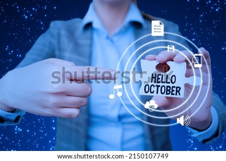 Text caption presenting Hello October. Business idea Last Quarter Tenth Month 30days Season Greeting Lady in suit pointing puzzle piece representing innovative thinking.