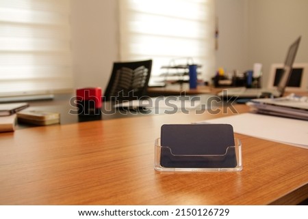 Business card, blue business card with holder on the office desk, company idea concept