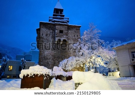 Vratsa by night. Magical winter landscape of the city of Vratsa, Bulgaria. Winter blue hour picture of fortified stone clock tower and covered with snow urban skyline.