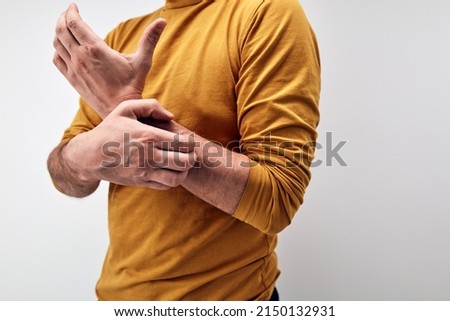 Adult man with hand, arm and wrist itchiness.