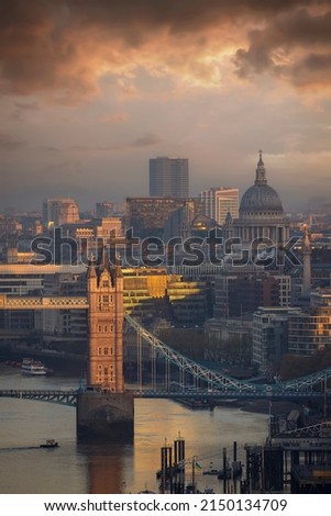 Idyllic sunrise view to the Tower Bridge and St. Pauls Cathedral in London, England
