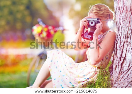 woman with camera relaxing after bicycle ride