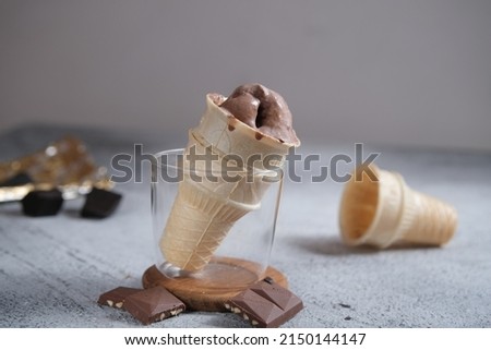 Melted Chocolate Ice cream cone, on a wooden table