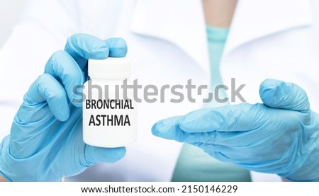Bronchial asthma text on a jar in the hands of a doctor, a medical concept