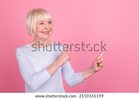 Photo of pretty aged lady look indicate fingers empty space promo follow comment suggest discount isolated over pink color background