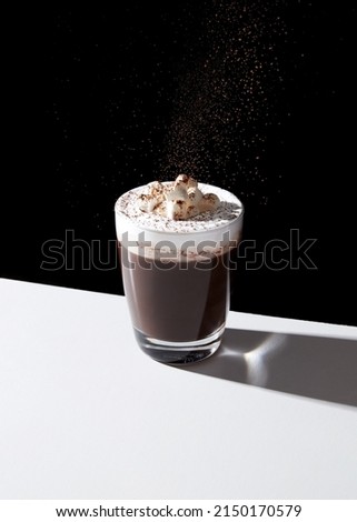 chocolate with whipped cream and marshmallow on black background