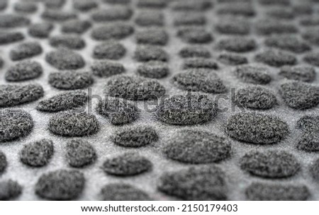Black and gray spotted background. Textured fur surface