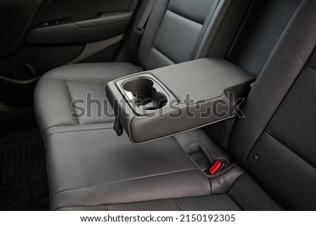 Leather armrest for storing things, moves and opens in the interior of the car. Royalty-Free Stock Photo #2150192305