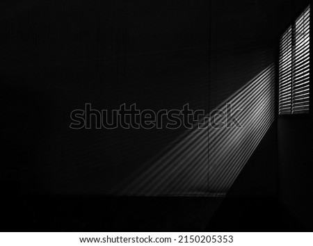 under exposure view of a window with shutter in a living room. Aluminium louver stripe pattern sunblind windows shutter at the office building.  home modern decoration. Royalty-Free Stock Photo #2150205353