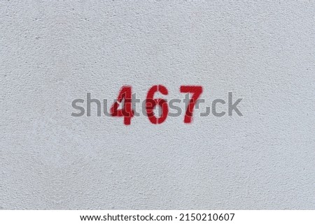 RED Number 467 on the white wall. Spray paint.
