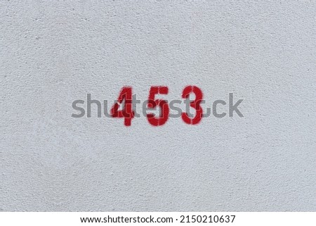 RED Number 453 on the white wall. Spray paint.
