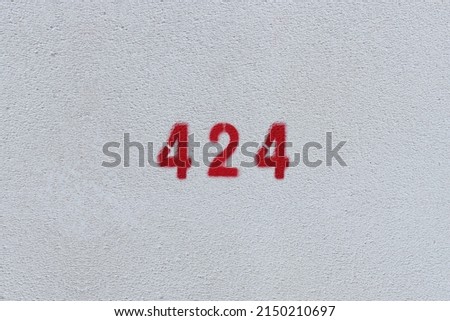 RED Number 424 on the white wall. Spray paint.
