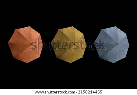 Top view, Set three colours umbrella isolated on black background, stock photo, invesment, business, summer concept, orange gold pastel blue violet colors