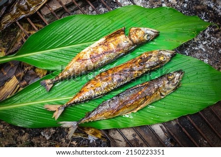 fish grilling on banana leaf. Food in camping.
