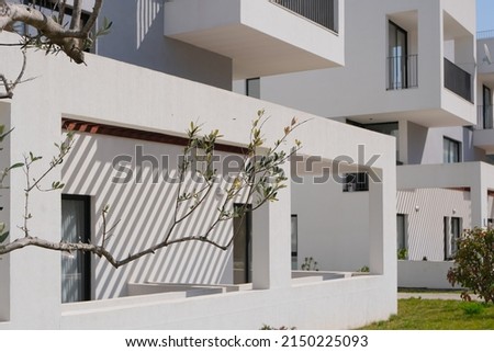 new contemporary residential construction architecture background. white modern house facade exterior Royalty-Free Stock Photo #2150225093