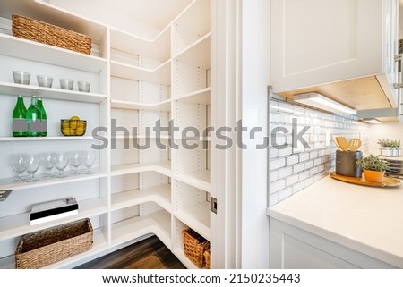 pantry and mudroom with white walls shelving hardwood floor Royalty-Free Stock Photo #2150235443