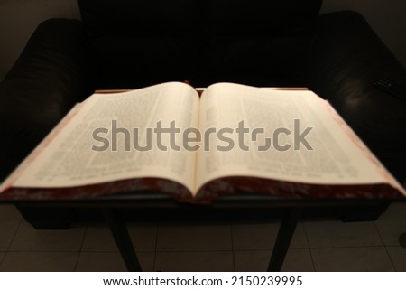The Babylonian Talmud Talmud is open on a blurry stand, a dark back angle and light on the book is an inspirational image. Royalty-Free Stock Photo #2150239995