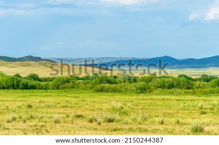 steppe, prairie, veld, veldt - grassy plain in the temperate and subtropical zones of the northern and southern hemisphere. Plateau. Hills. Royalty-Free Stock Photo #2150244387
