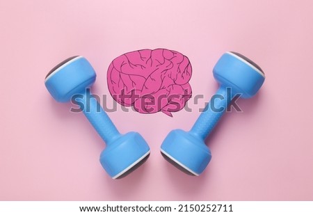 Pump your brain. Dumbbells with paper-cut brain on pink background