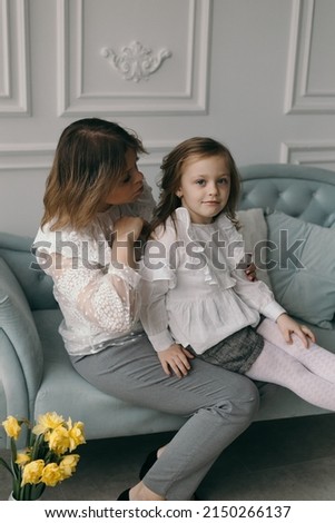Portrait of little preschooler girl kid piggyback excited young mother have fun playing together at home, happy mom and daughter hug cuddle show love, enjoy family relaxing weekend in living room