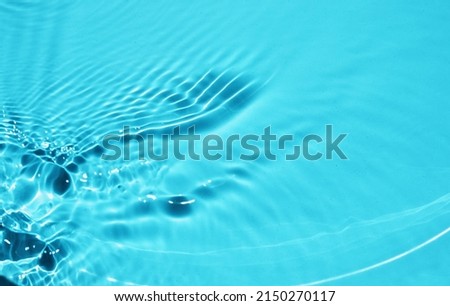 Defocused surface texture with splashes and bubbles. Abstract nature background. Cosmetic moisturizer water blue.