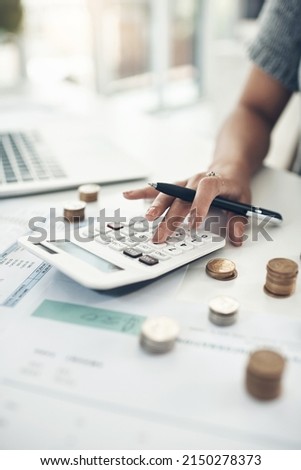 Keep an eye on your income. Closeup shot of an unrecognisable businesswoman calculating finances in an office. Royalty-Free Stock Photo #2150278373
