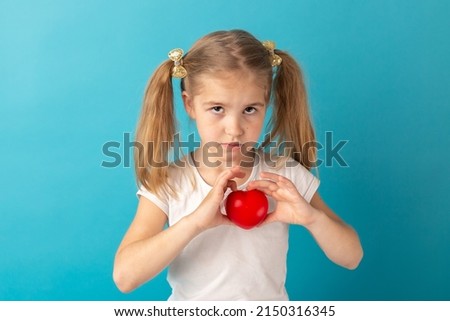 Sweet girl holding red heart. Valentines day or healthcare, medical concept. Peace on the world. No war, stop war.