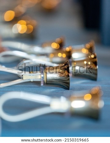 Closeup of small handbells on table Royalty-Free Stock Photo #2150319665