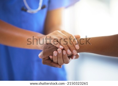 Emotional comfort stored in fingerprints. Shot of an unrecognizable doctor holding hands with her patient during a consultation. Royalty-Free Stock Photo #2150323261