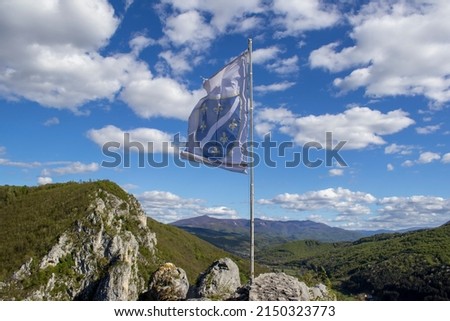 Old flag of Bosnia and Herzegovina waving in the wind. It was used in period 1992-1998. A white field with a blue shield bearing six Bosnian Golden Lilies in the centre.
 Royalty-Free Stock Photo #2150323773