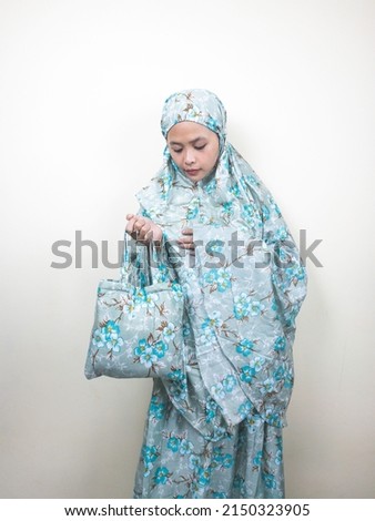 portrait of beautiful muslim woman wearing muslim hijab scarf mukena isolated on white background