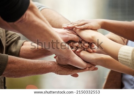 Our passion and dedication will take us to the top. Closeup shot of a group of unrecognisable people joining their hands together in a huddle. Royalty-Free Stock Photo #2150332553