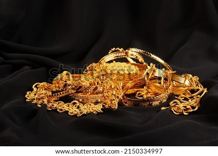 Lots of golden luxury jewels over a black background