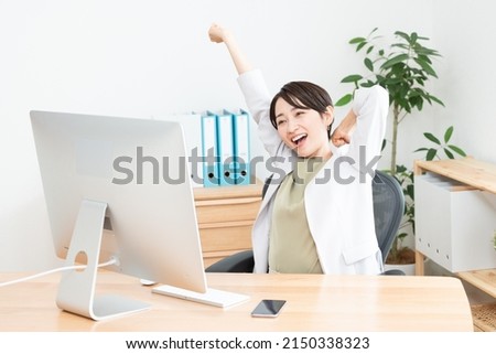 Asian woman working in office Royalty-Free Stock Photo #2150338323