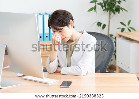 Asian woman working in office Royalty-Free Stock Photo #2150338325