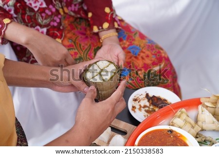 Burasak or buras is an Indonesian rice dumpling cooked with coconut milk packed inside a banana leaf pouch. It is a delicacy of the Bugis and Makassar people of South Sulawesi. Royalty-Free Stock Photo #2150338583