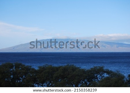 beautiful ocean view with mountains and clouds in the background