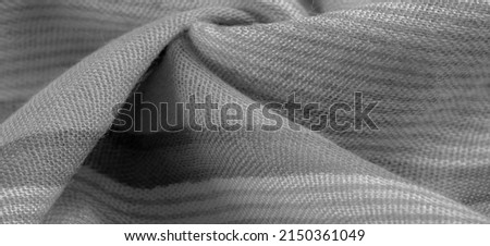 Monochrome gray silk fabric, Texture. Background. a photograph or picture developed or executed in black and white or in varying tones of only one color.