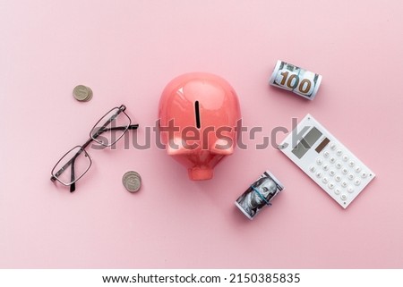 Money investments concept. Piggy bank with money and calculator.