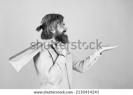 brutal bearded male man hold present or gift package, presenting product, copy space