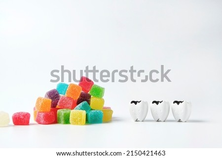 Decay and cavity teeth look at heap of colorful sweet jelly candy, eating too much sugar can cause tooth decay