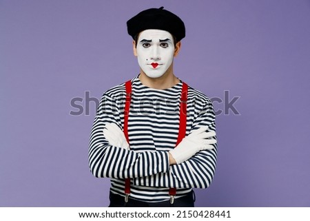 Strict concerned charismatic stunning fun young mime man with white face mask wears striped shirt beret look camera hold hands crossed isolated on plain pastel light violet background studio portrait